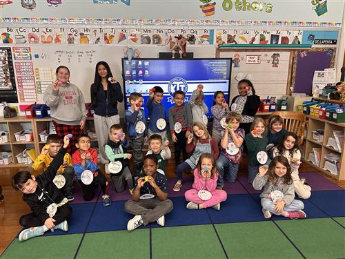 Students post with homemade crafts